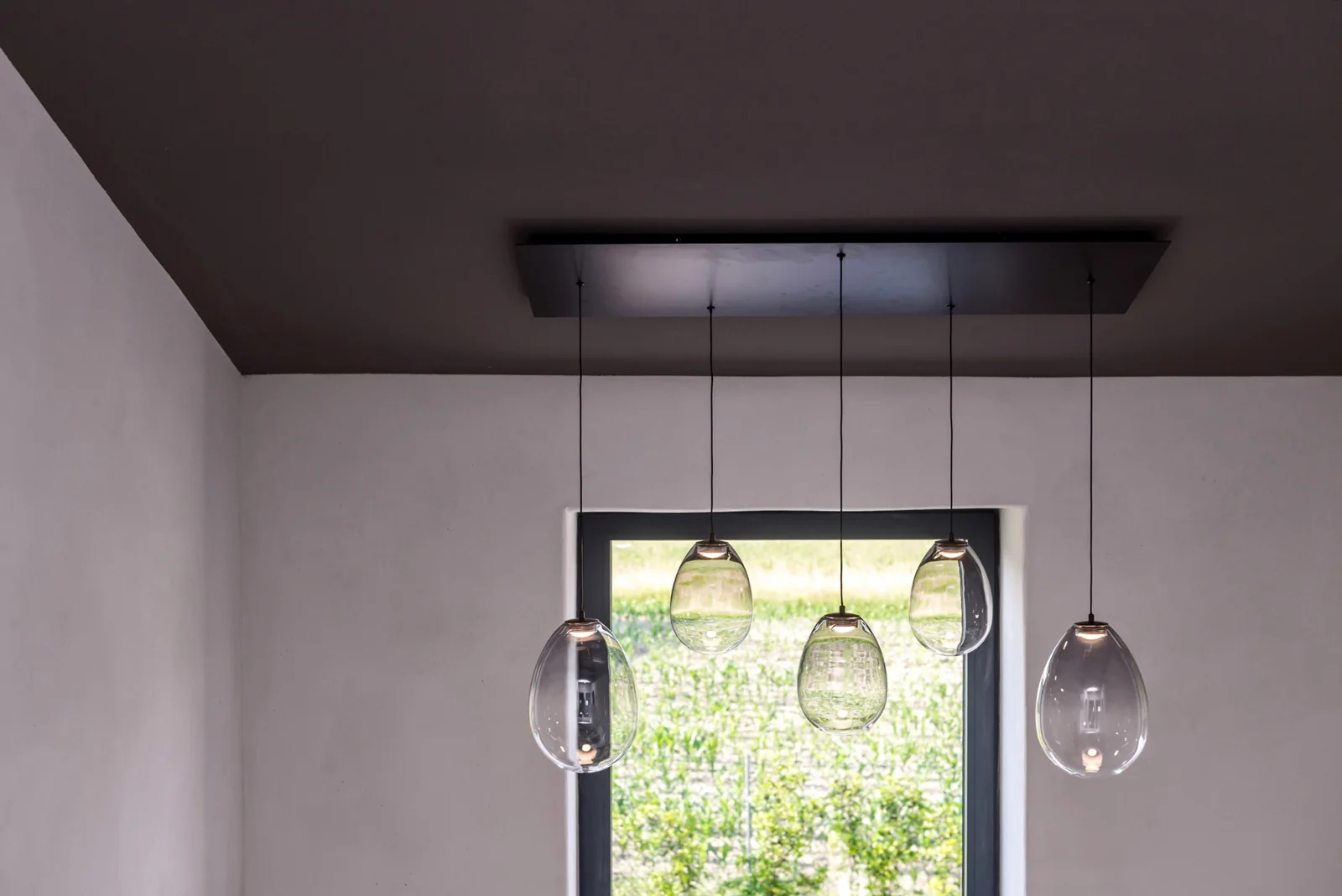 Glass pendant lamps suspended by a window