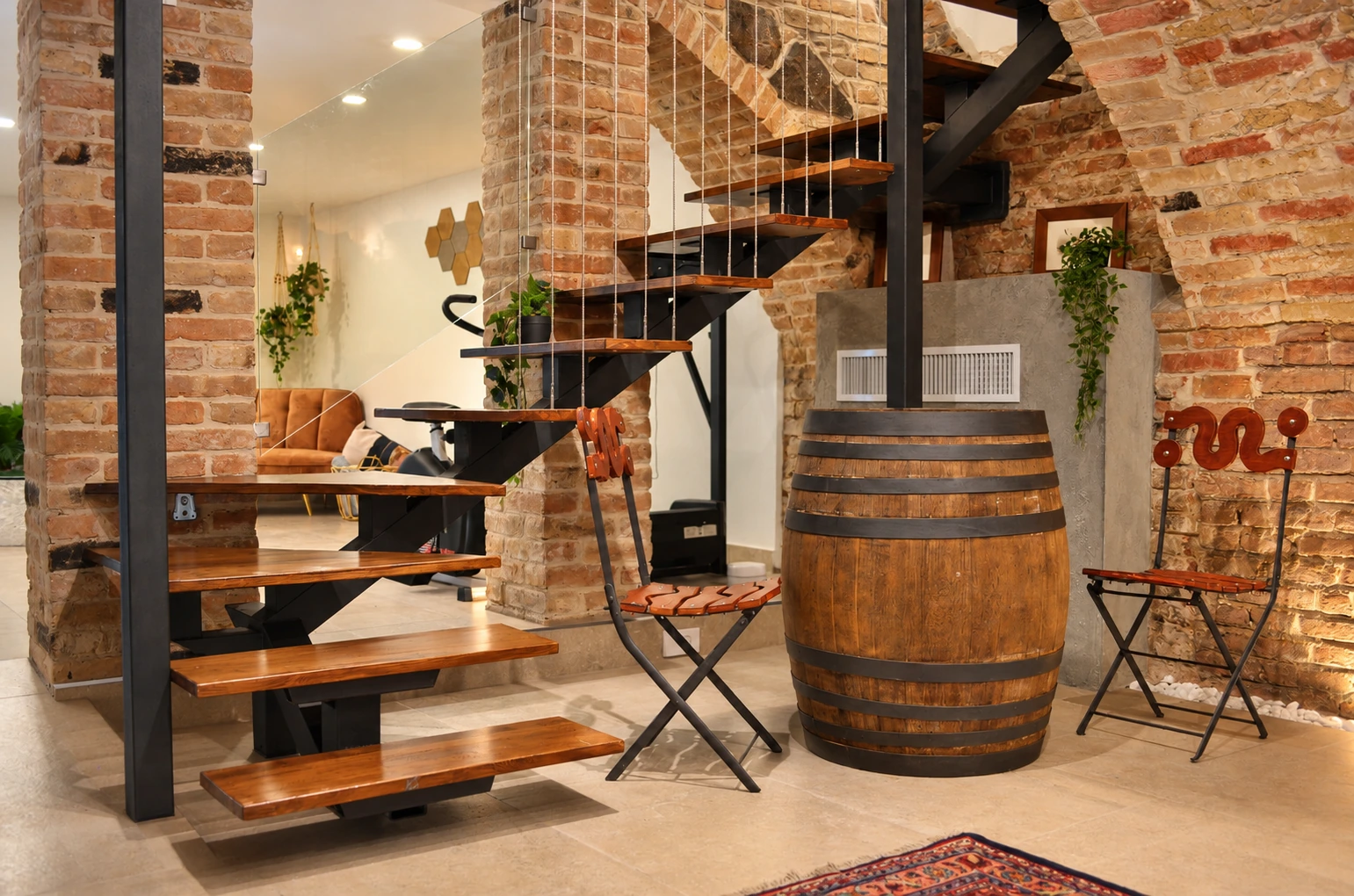 Restored brick-and-timber staircase with vintage barrel in historic basement