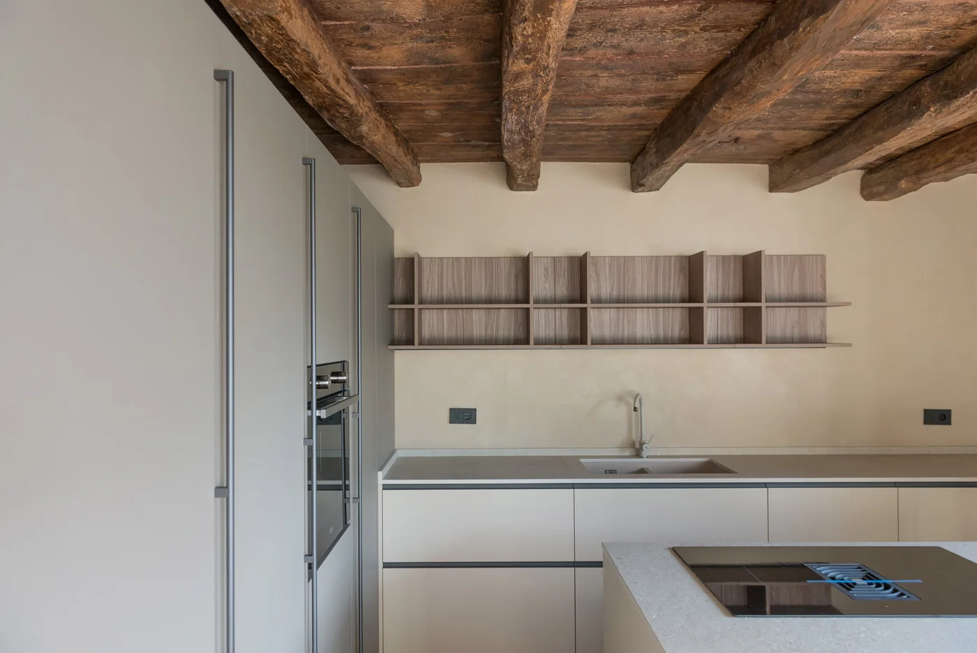 Modern fitted kitchen with exposed timber beams